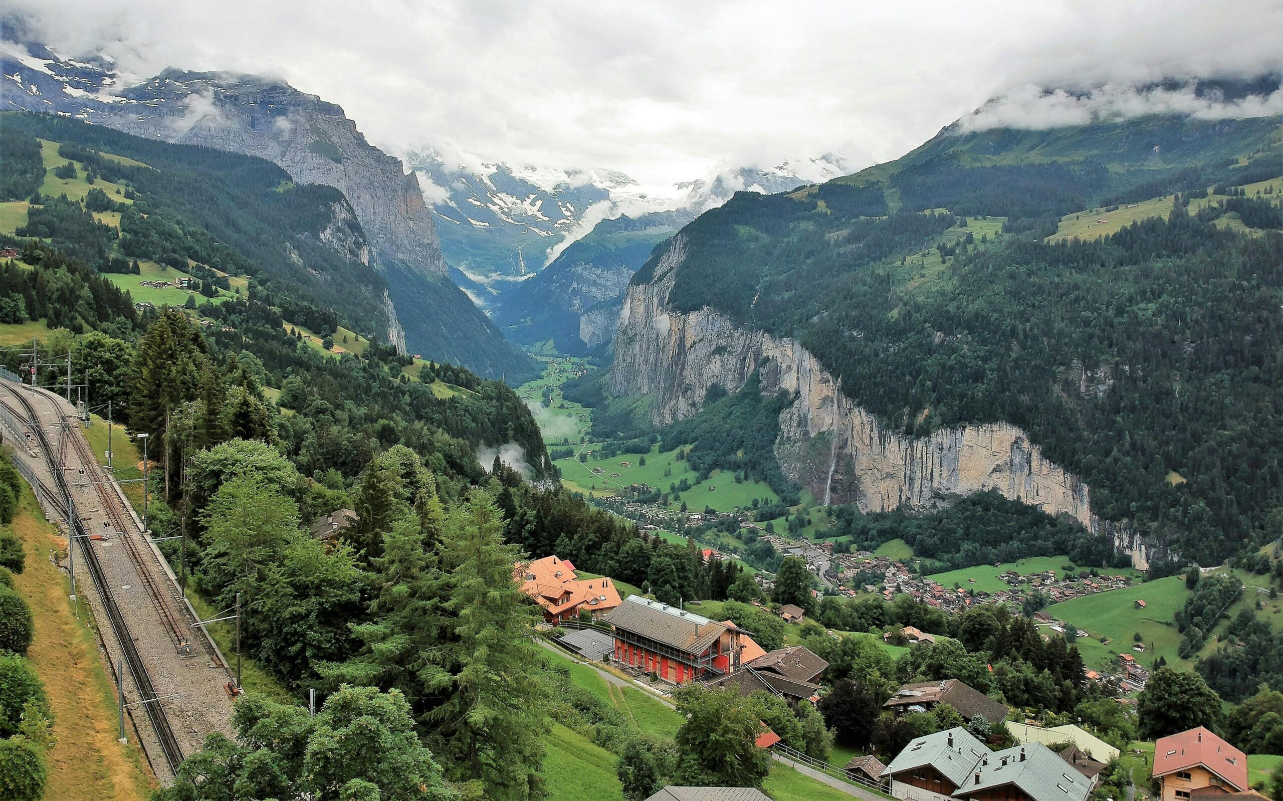 Explore the breathtaking landscape of Lauterbrunnen Valley in Switzerland, featuring lush greenery and majestic mountains.