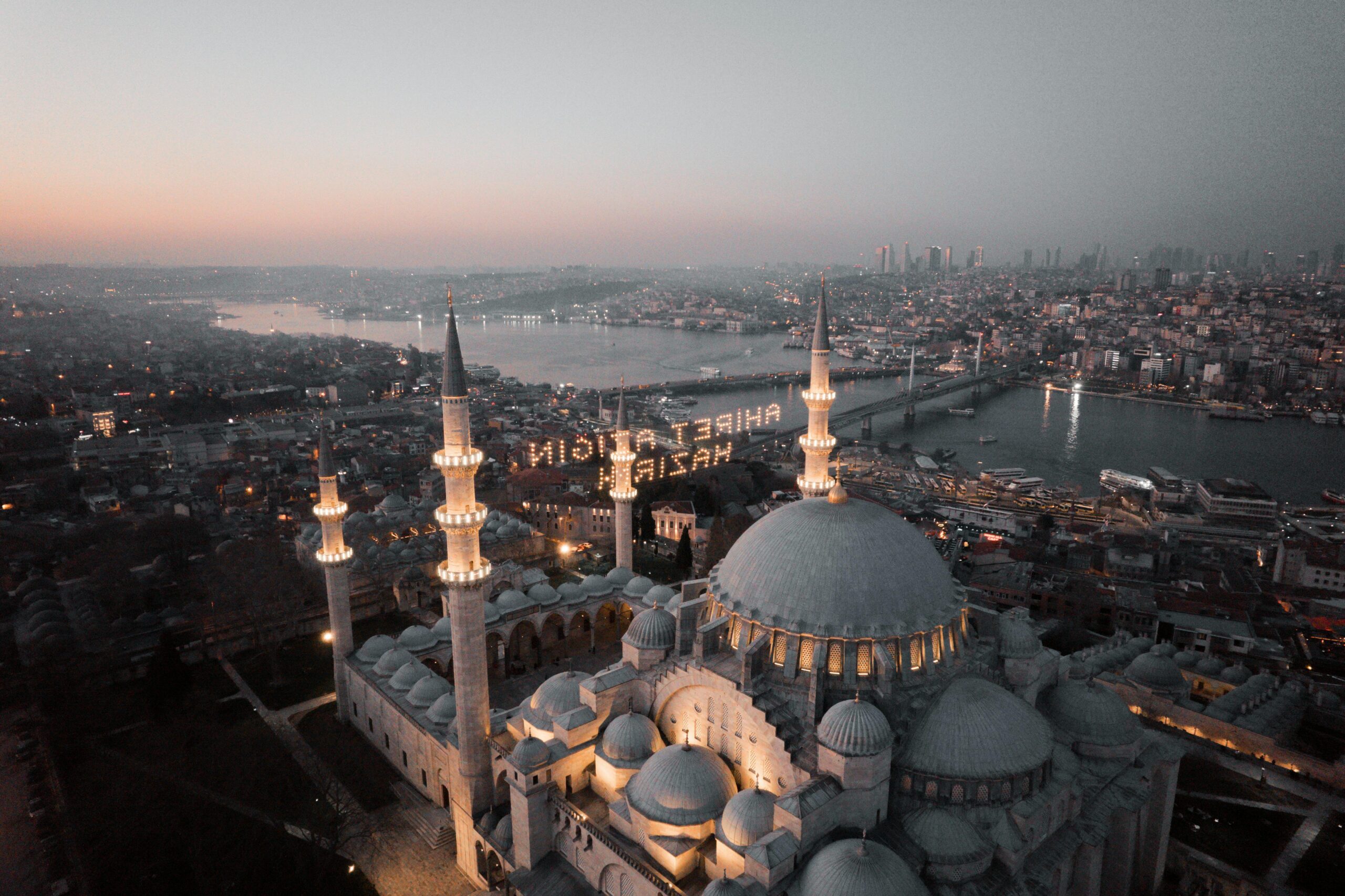 Stunning aerial view of Suleymaniye Mosque in Istanbul with cityscape at sunset.