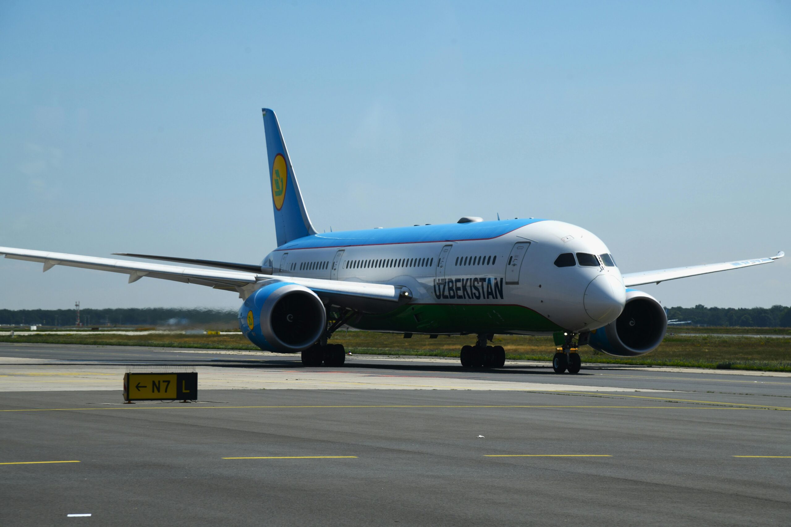Uzbekistan Airways Boeing 787-8 taxiing at Frankfurt Airport on a clear day.