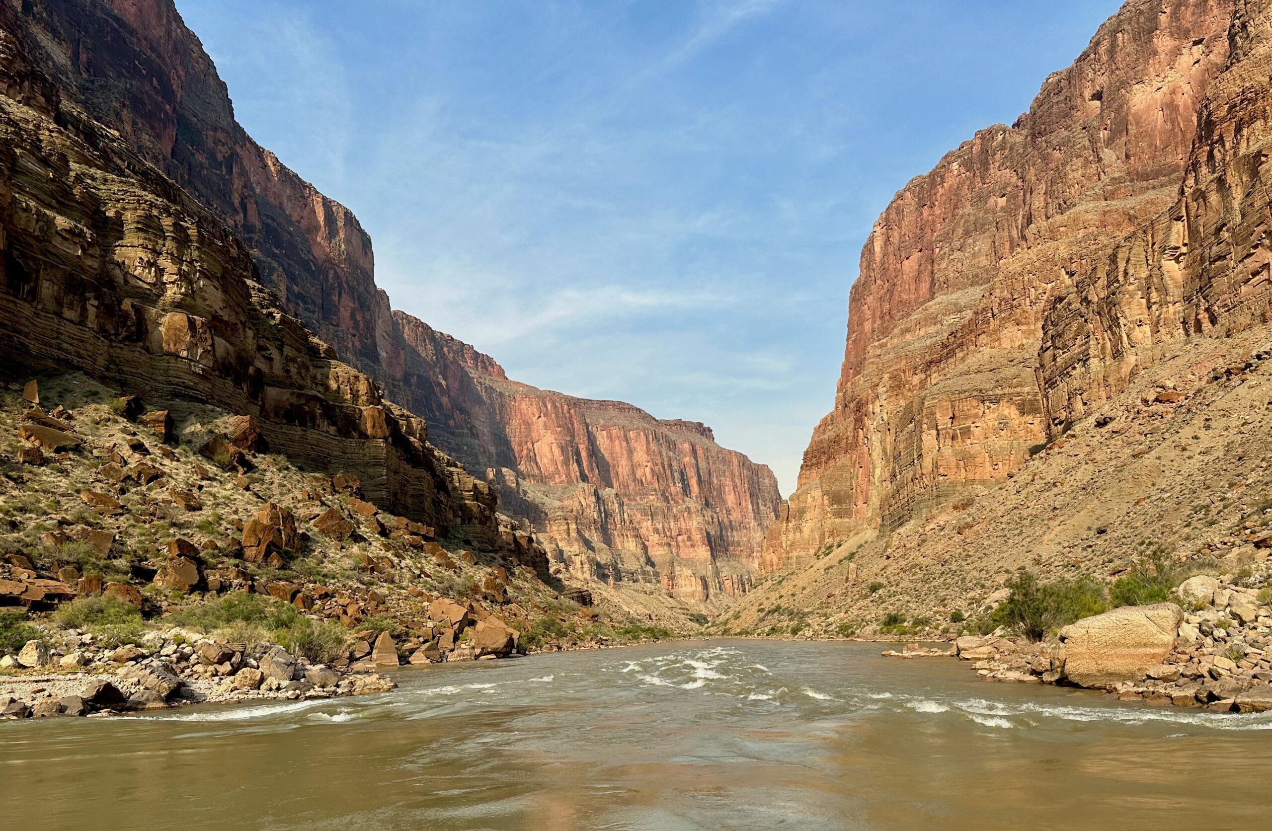 Stunning landscape of the Colorado River cutting through the Grand Canyon's rugged cliffs.